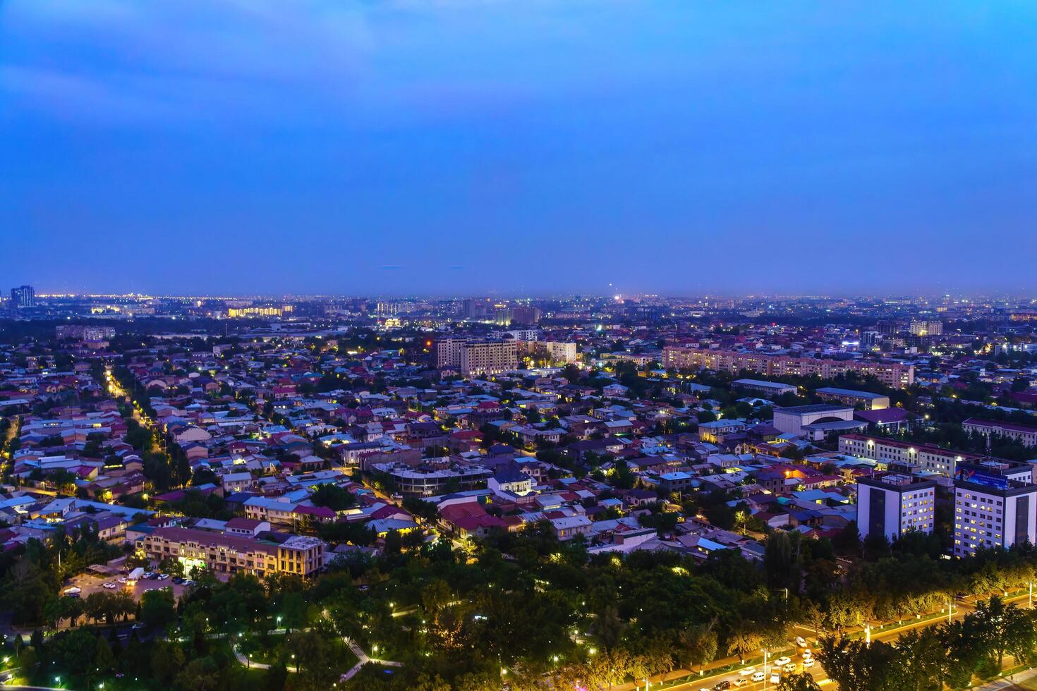 Uzbekistan, Tashkent - September 29, 2023 Top view from the observation deck on the Tashkent TV tower to the central part of the city covered with smog at nighttime . Air polution. photo