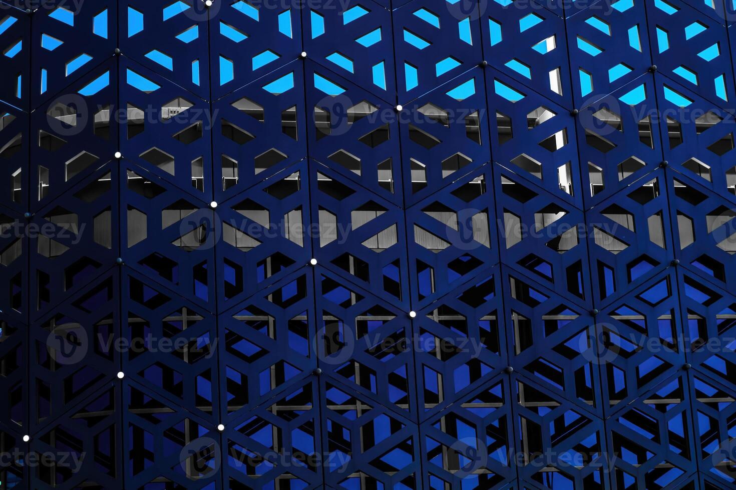 The texture of the cladding of a building made of metal aluminum panels with a carved pattern. Abstract background. photo