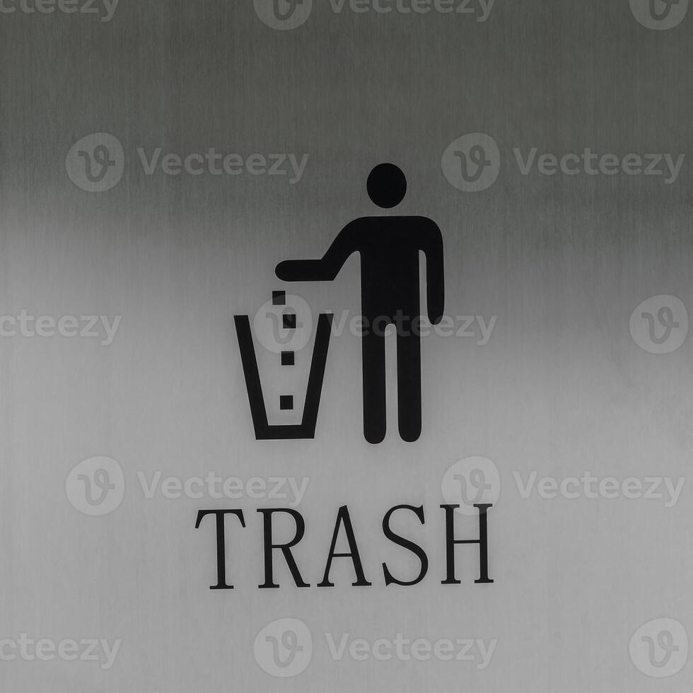 Icon of a person throwing trash into a trash can on a metal background. photo
