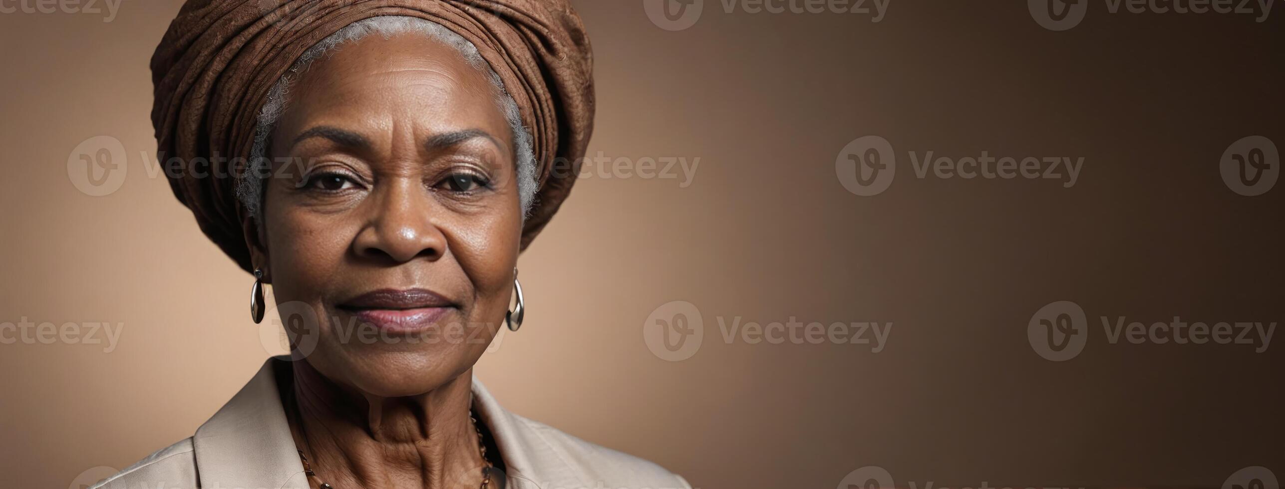 African American 70S Elderly Woman Isolated On A Hazel Background With Copy Space. photo