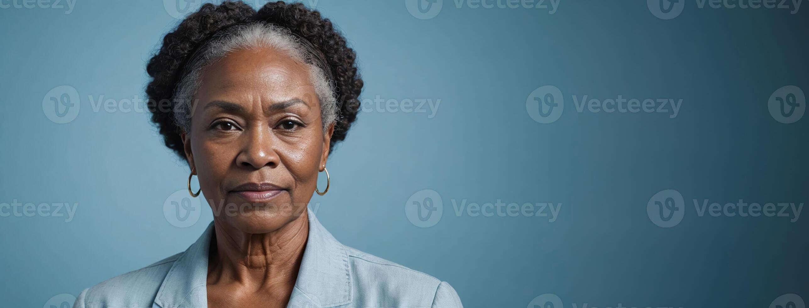 African American 60S Elderly Woman Isolated On A Light Blue Background With Copy Space. photo