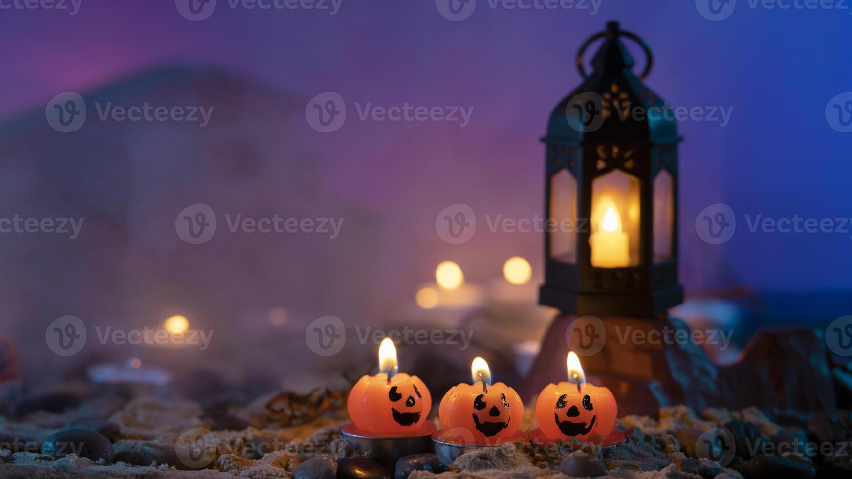 Halloween background, 3 pumpkin-shaped candles in the foreground, an old lamp on a rock against a blue out-of-focus background photo