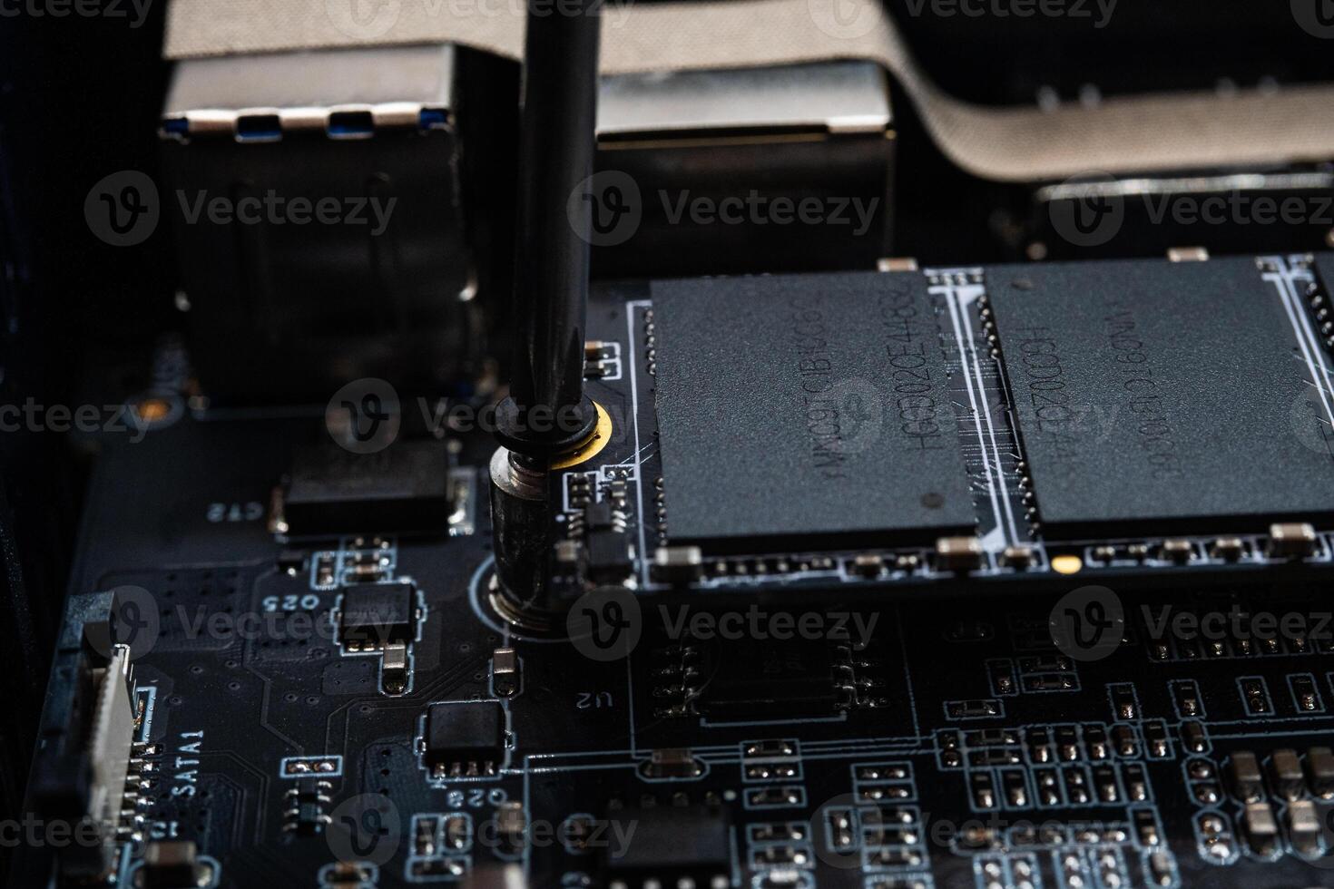 Screwing MSATA nvme M2 with a screwdriver for connecting fast modern SSD photo