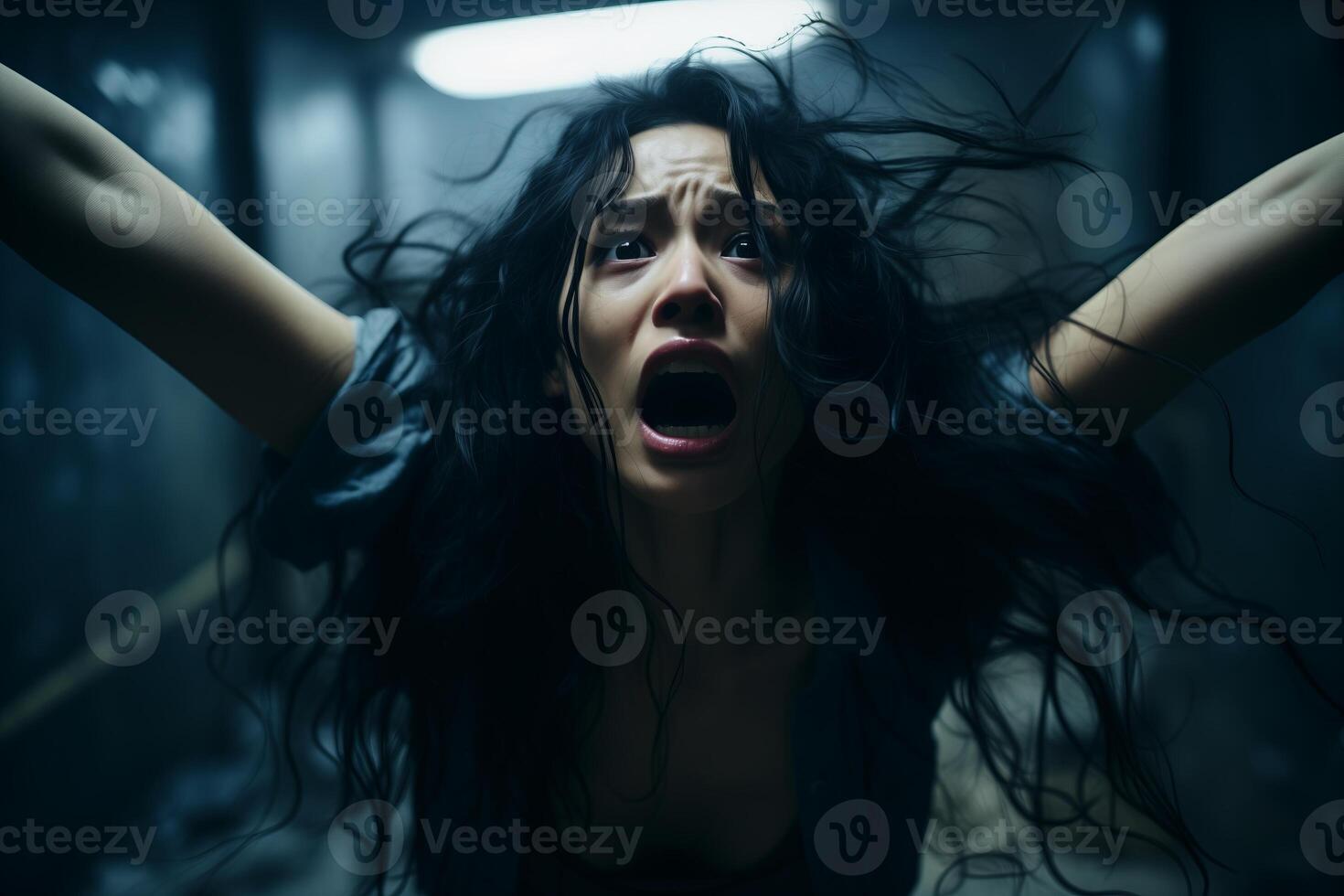 A woman standing with her hands lifted in the air. photo