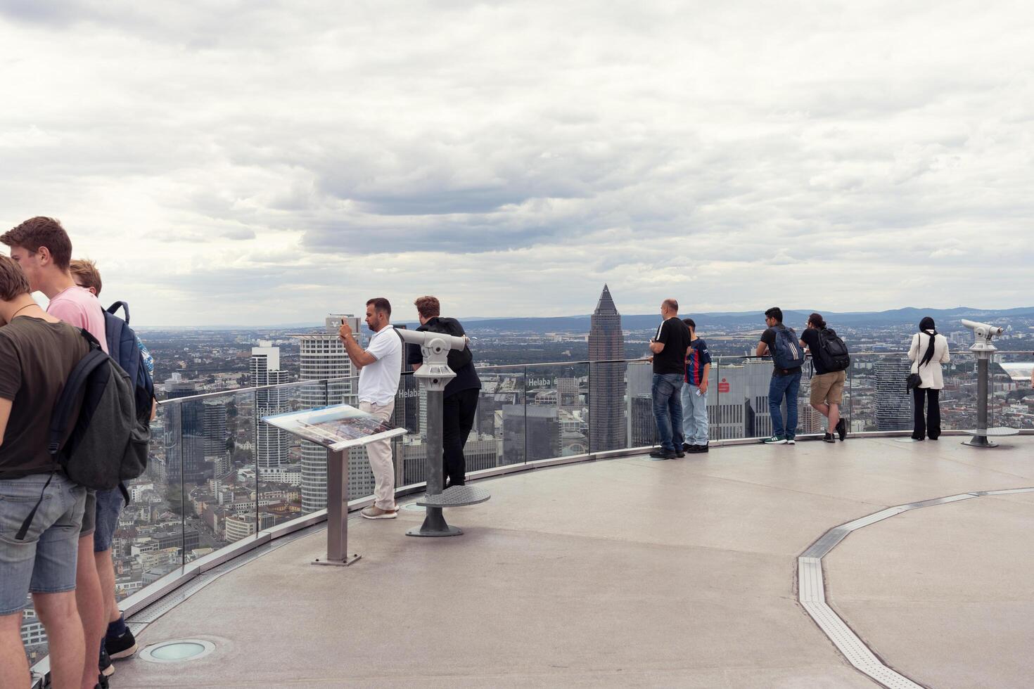 Frankfurt, Germany, August 08, 2023. Excursion. People look at the city from a tall building. Many people are on the observation deck of a high-rise building and admire the beauty of the city. photo