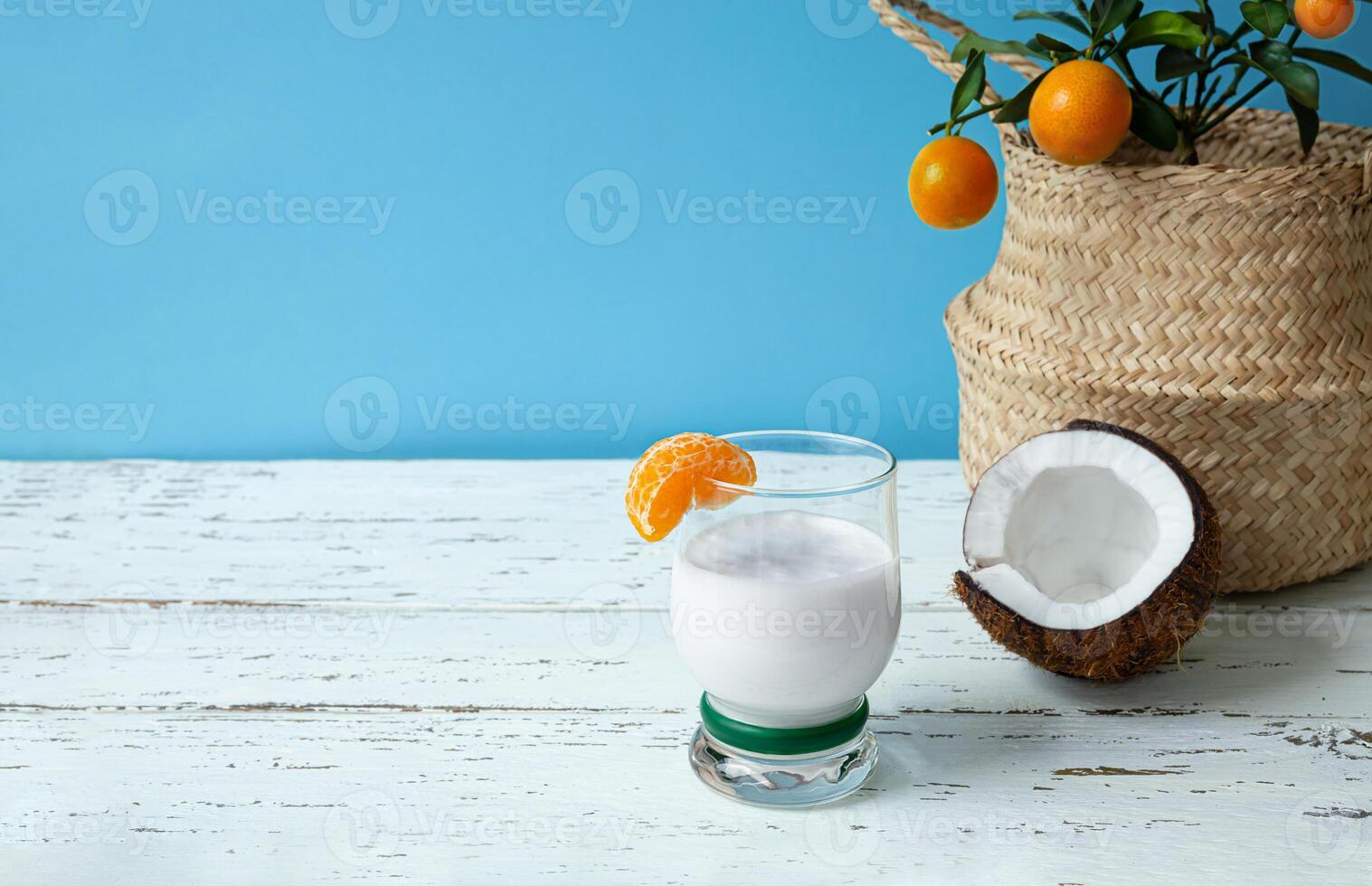 A glass of coconut milk smoothie and coconut photo