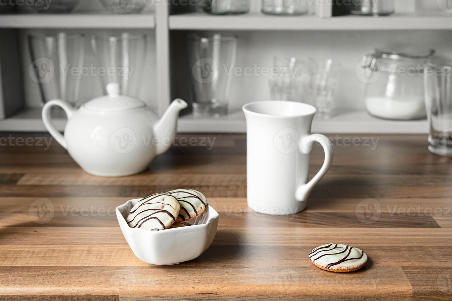 White tea cup, teapot and cookies photo