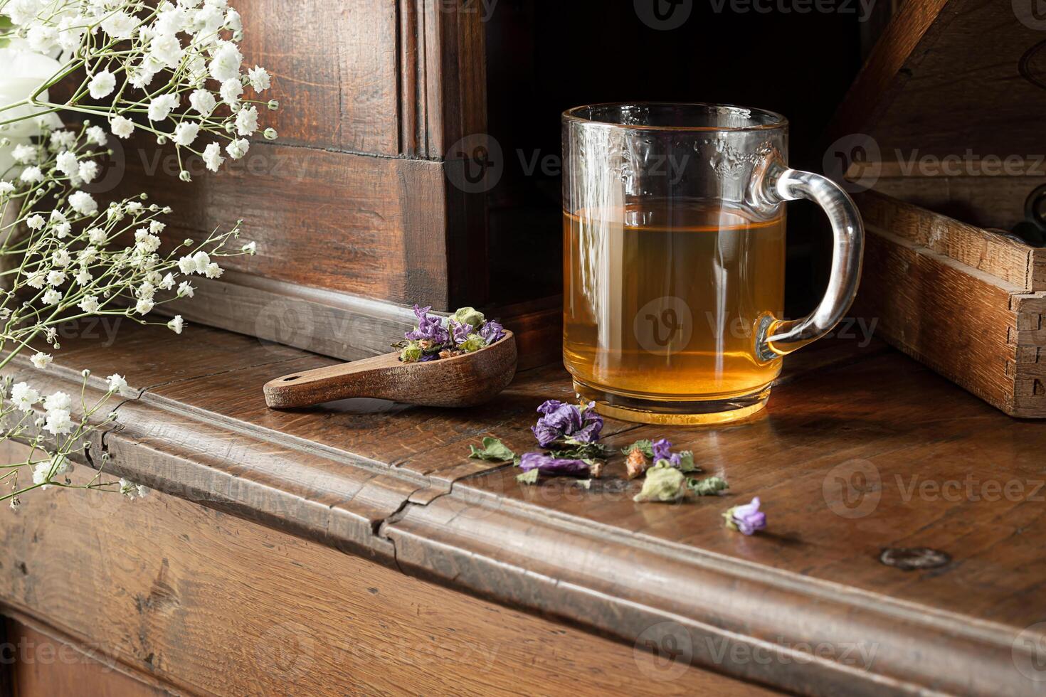 A cup with herbal tea on an sideboard photo