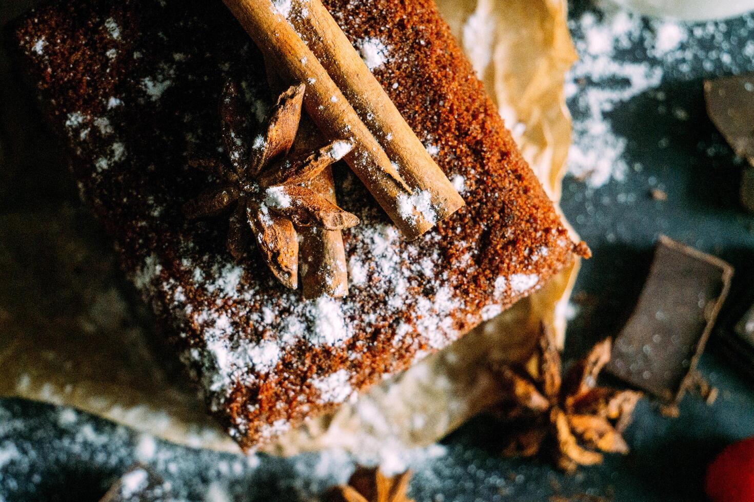 a slice of christmas cake with cinnamon, star anise and chocolate photo