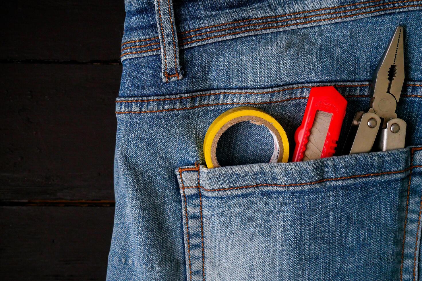 a pair of scissors and a pair of pliers in a pocket photo