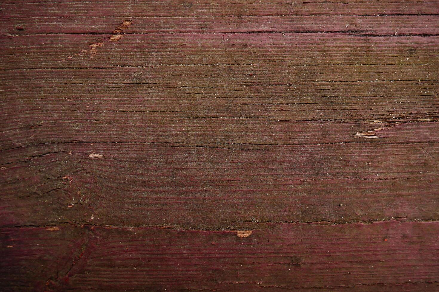 a close up of a wooden wall with a red paint photo