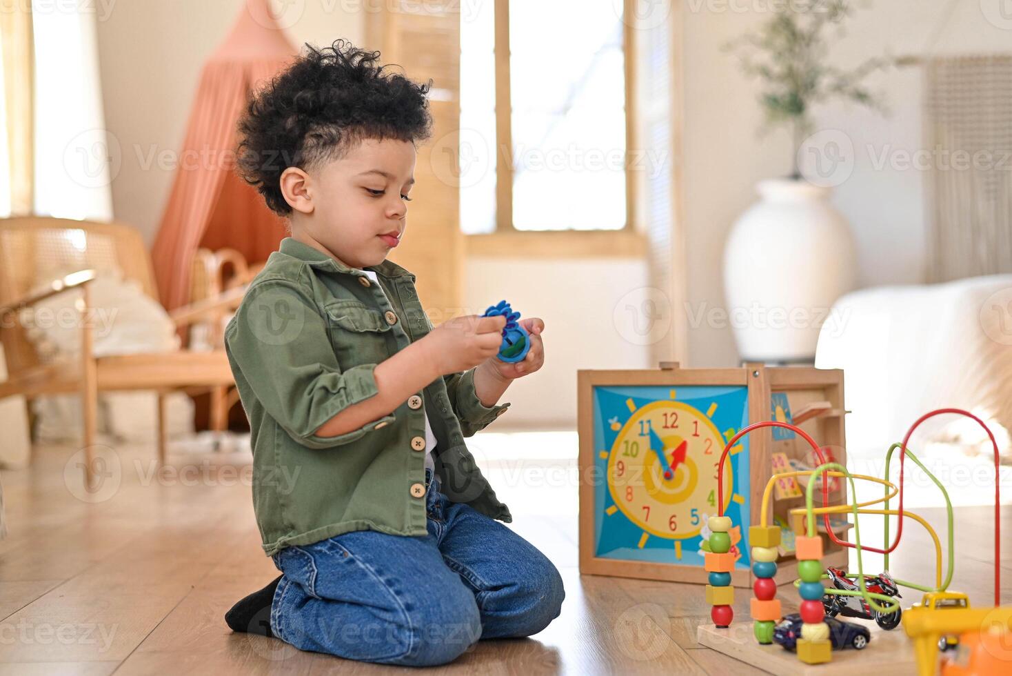 Concentrated latinos boy playing toys sitting on warm floor in modern living room. Baby development. Small tower. Learning creative concept photo