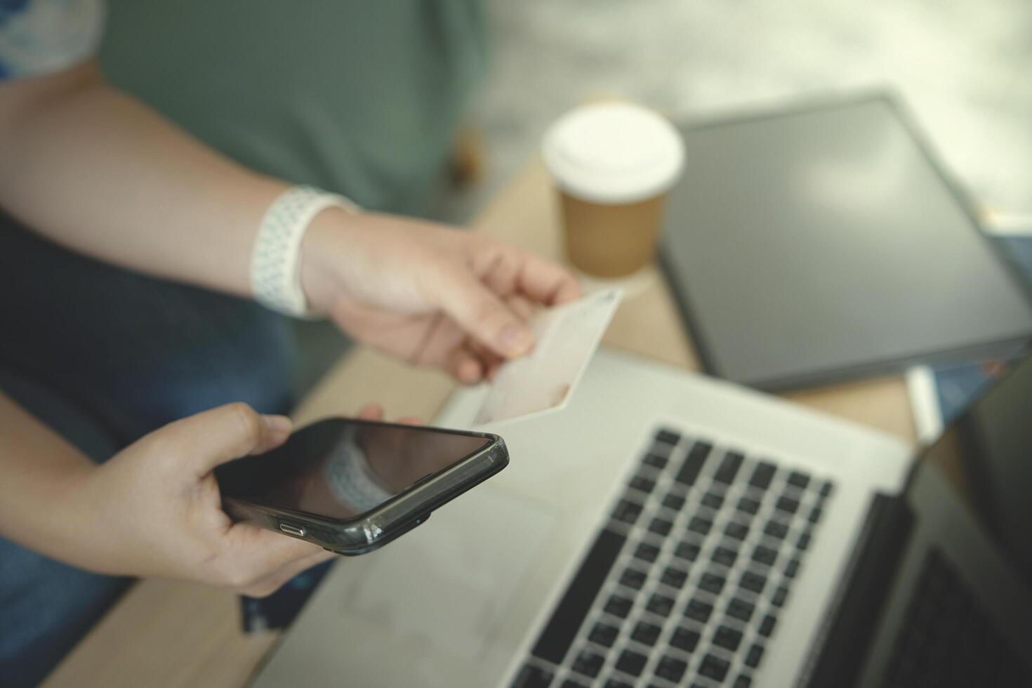 person using laptop payment credit card shopping online photo