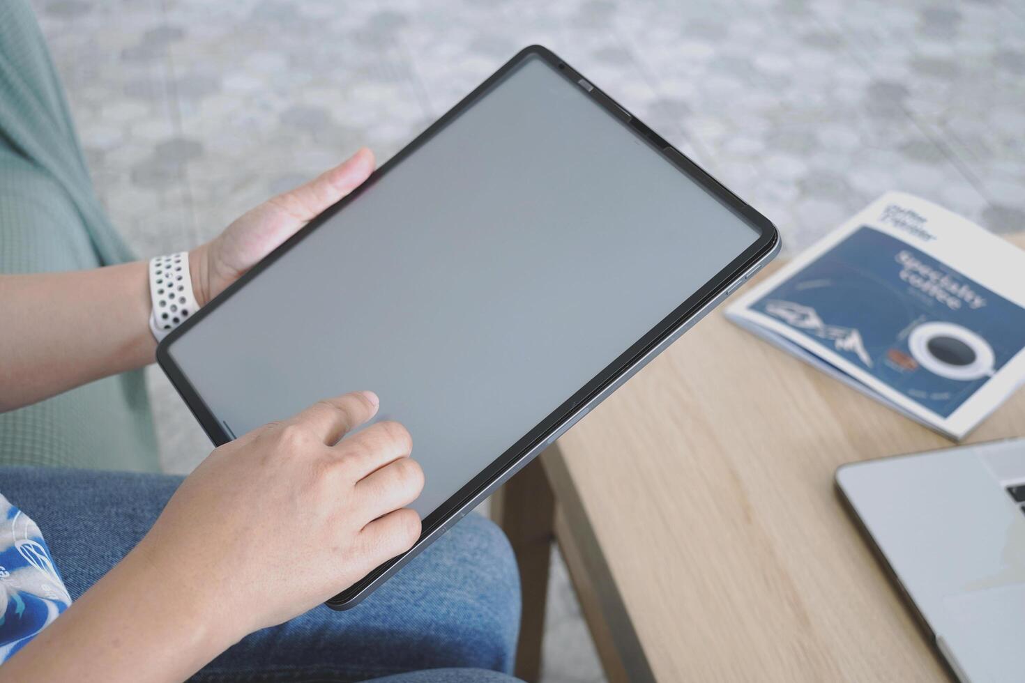 person using digital tablet in office photo
