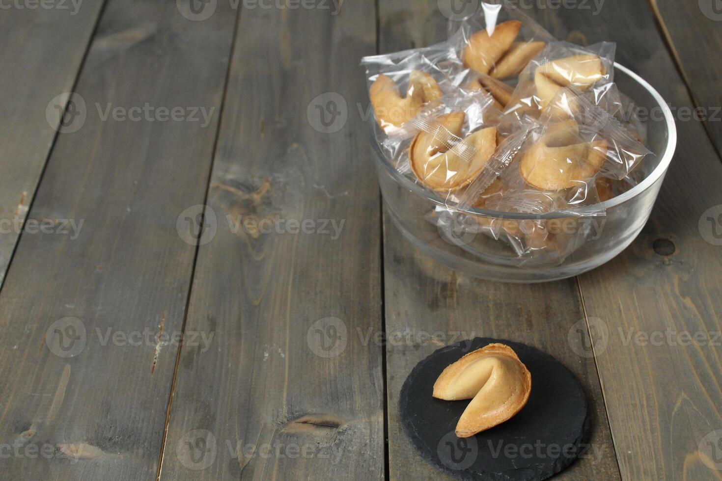 Chinese biscuits on a stand on a gray background with prediction text. Chinese New Year traditions. Copyspace photo
