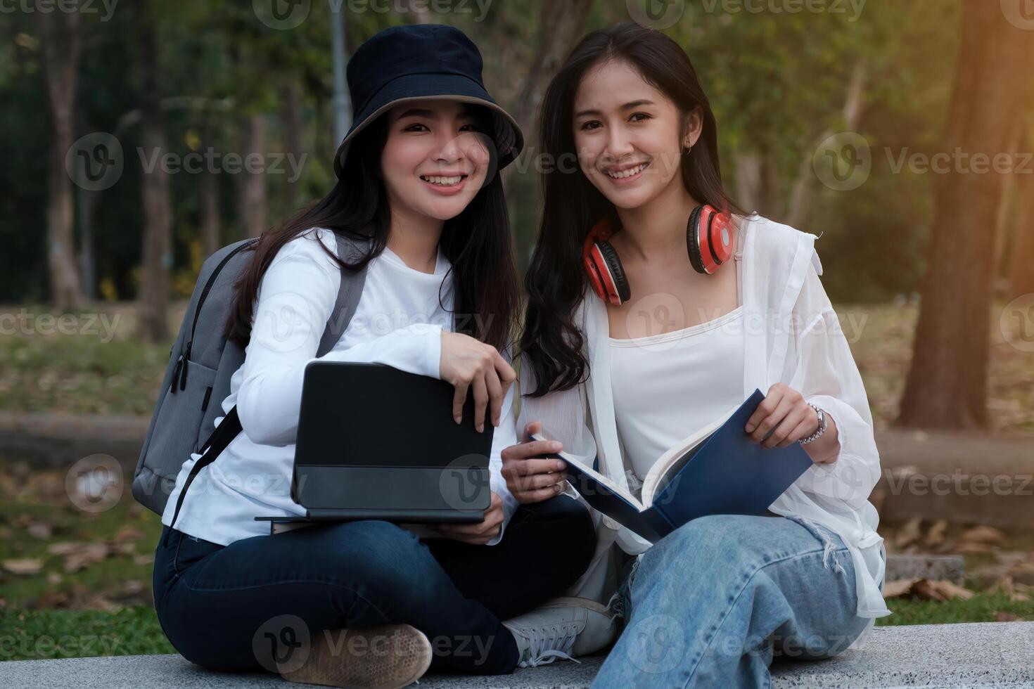 Friends or Family concept. Two Female using maps on tablet while travel. photo