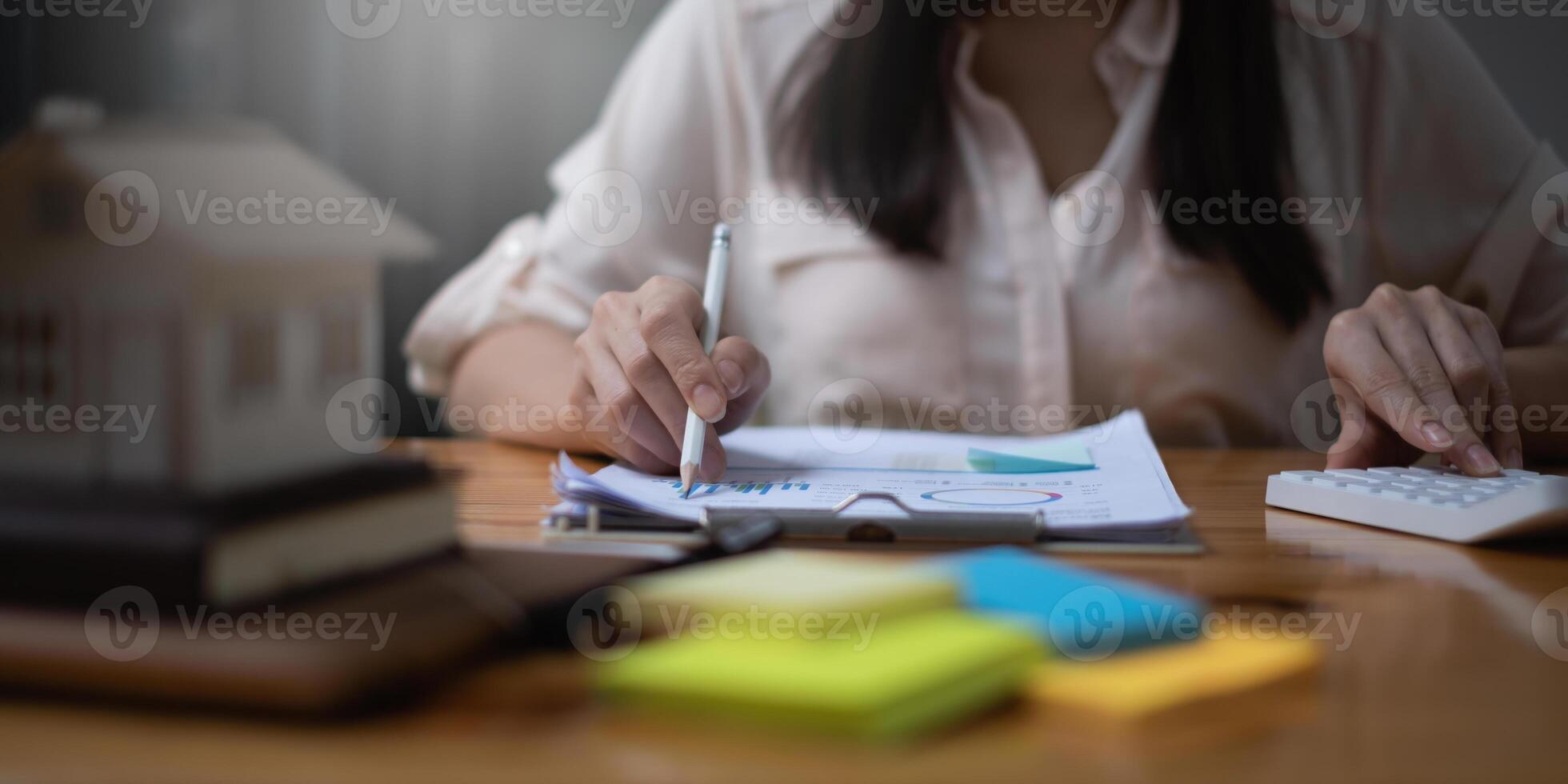 Expenses for the residence are being calculated by a accountant woman. The notion of tax deduction planning photo
