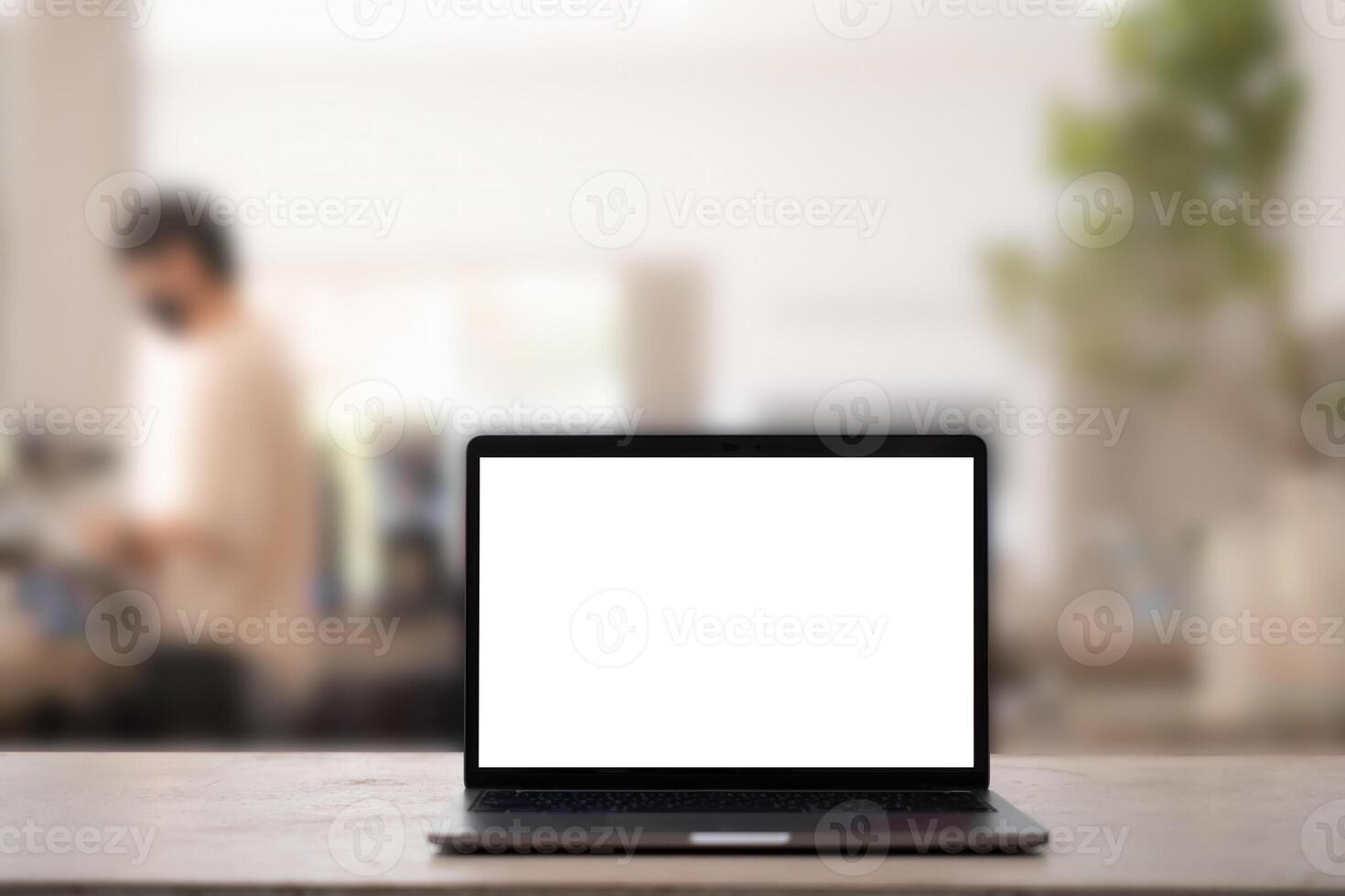 White blank screen tablet on modern working desk in coffee shop and barista on background photo