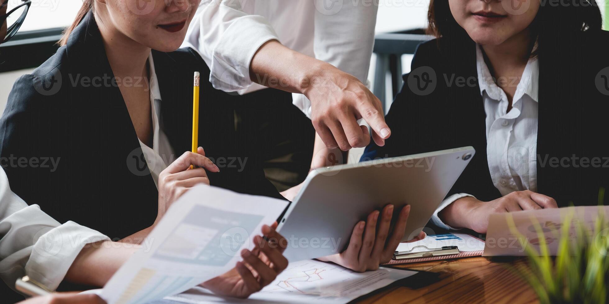 Group of Businesswoman and Accountant checking data document on digital tablet for investigation of corruption account . Anti Bribery concept. photo