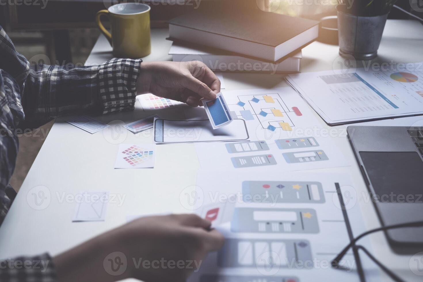 Closeup of male ux developer and ui designer about mobile phone app interface in living room at home. Creative digital development agency concept. photo