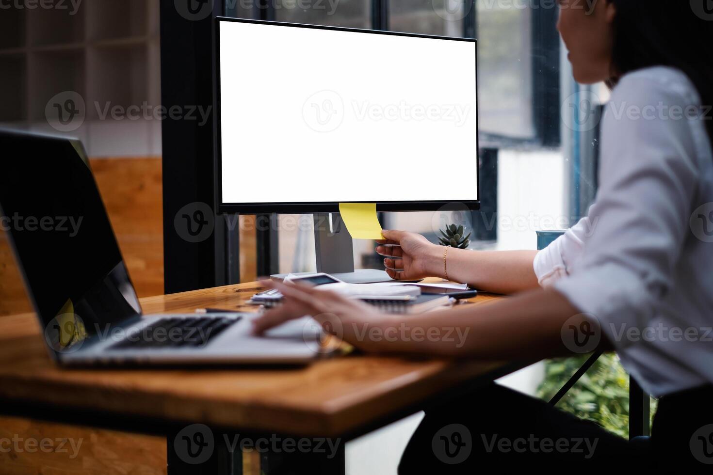 Mockup computer desktop with blank screen. Group of business people meeting and brainstorming by conference photo