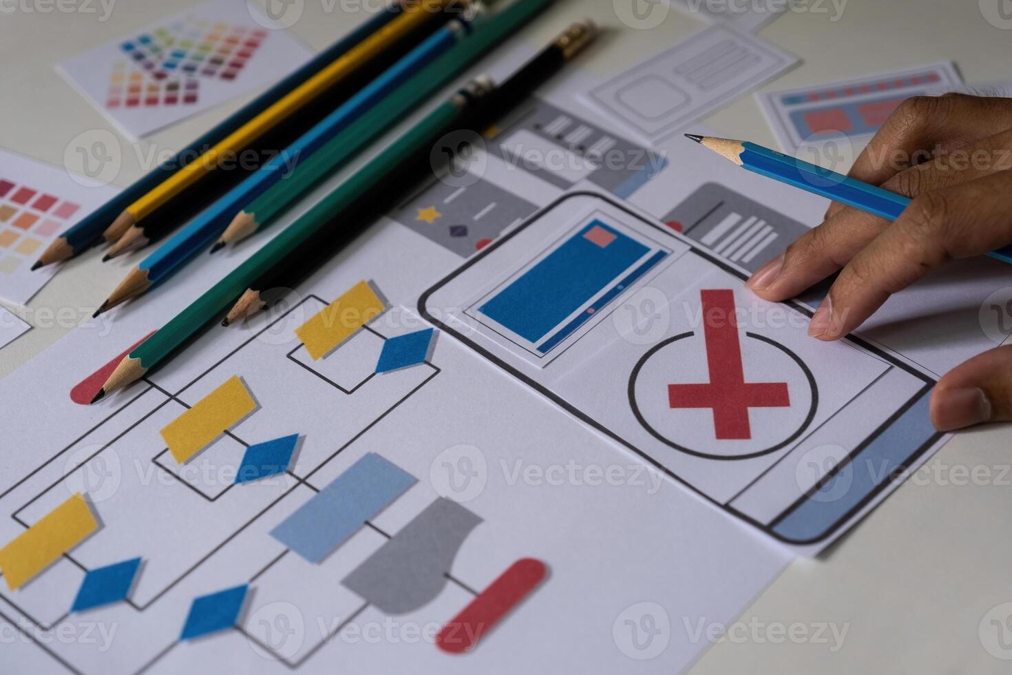 Designers drawing mobile ux app development concept. Man hold pencil with mockup ui. photo