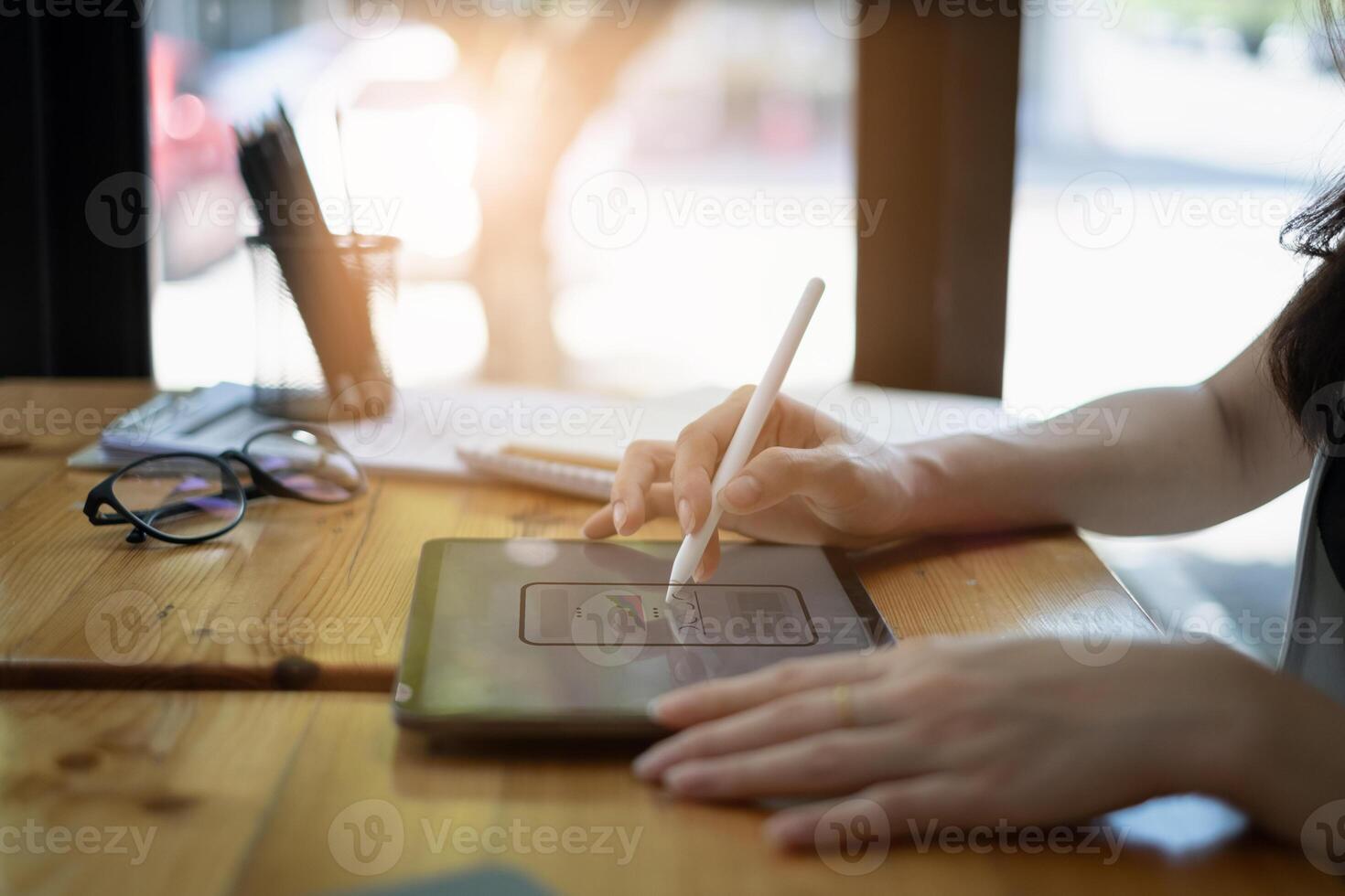 Closeup of female ux developer and ui designer about mobile phone app interface in living room at home.Creative digital development agency concept. photo