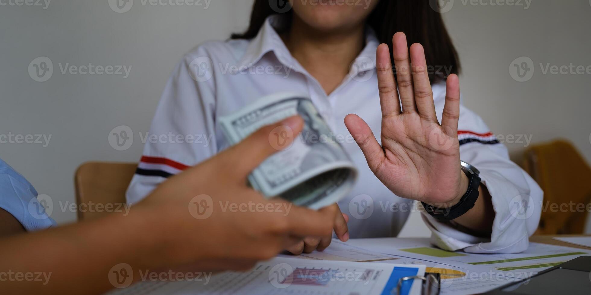 Woman of Commerce Rejecting the contractor's offer of black money in exchange for a permit in the deal. Concepts of corruption and anti-bribery. photo