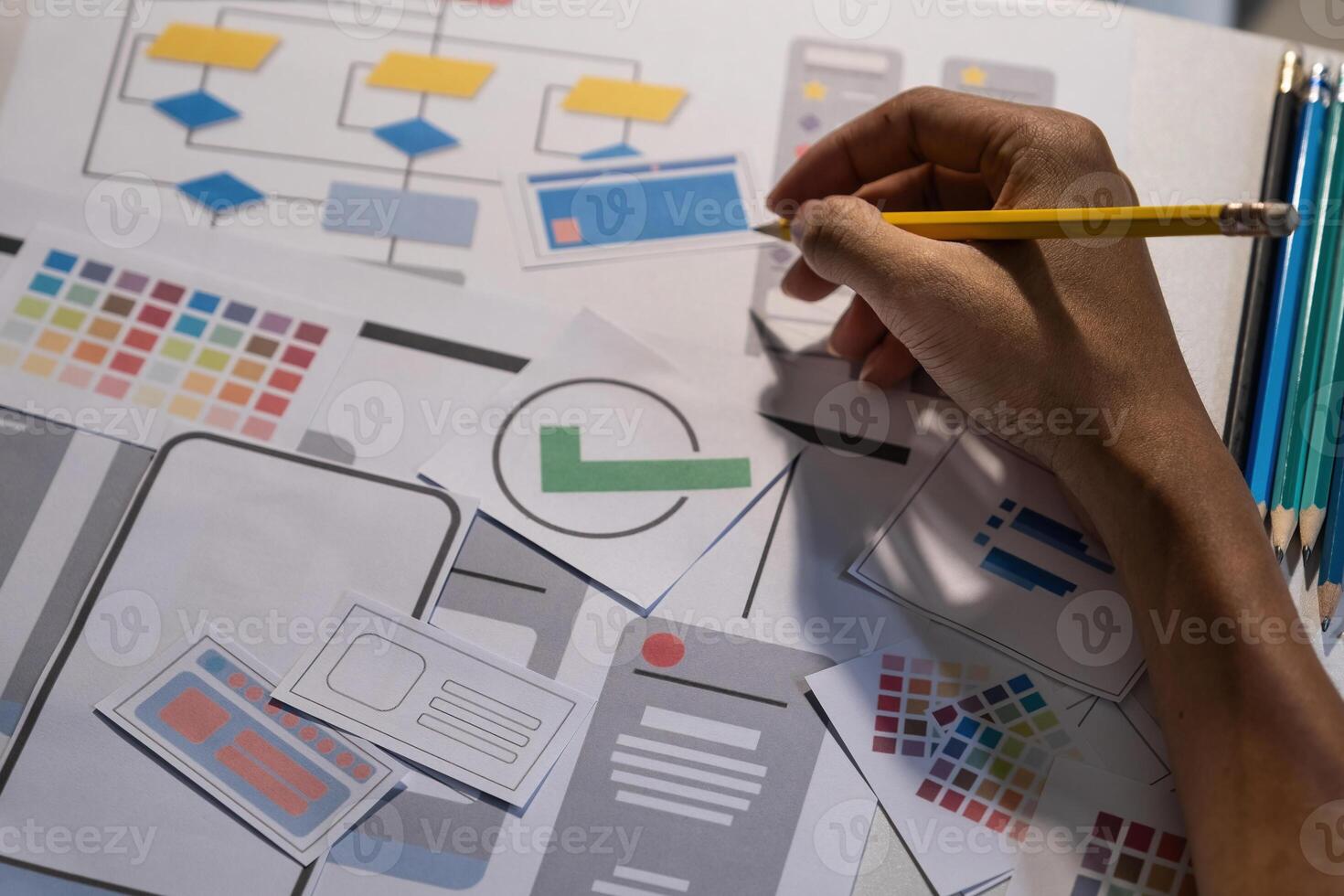 Designers drawing mobile ux app development concept. Man hold pencil with mockup ui. photo