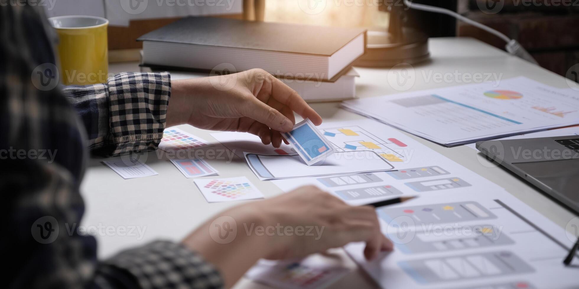 A close-up of an ux ui developer and an ui designer working on a mockup icon interface for a mobile app. photo