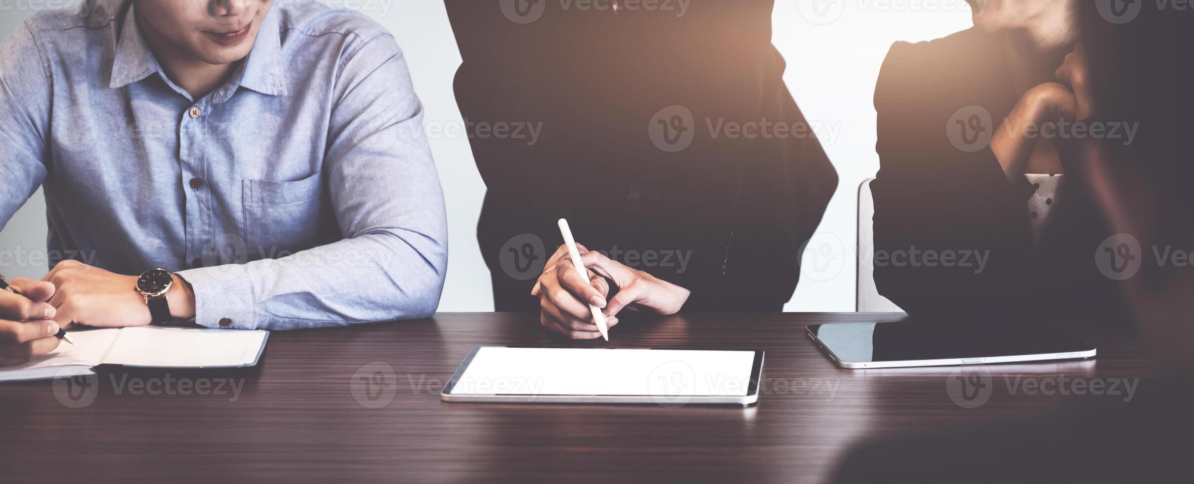 Group of Businesswoman and Accountant checking data document on digital tablet for investigation of corruption account . Anti Bribery concept. photo