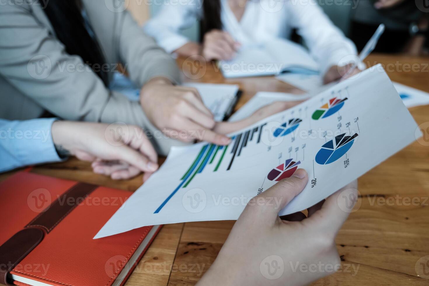 For the investigation of a corruption account, a group of businesswomen and accountants search data documents on a laptop. definition of anti-bribery. photo