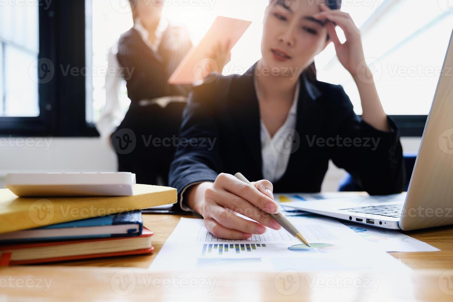 Stressed business woman hard working until morning and tired at table in office while project deadlines. finance, account, tax, audit concept. photo