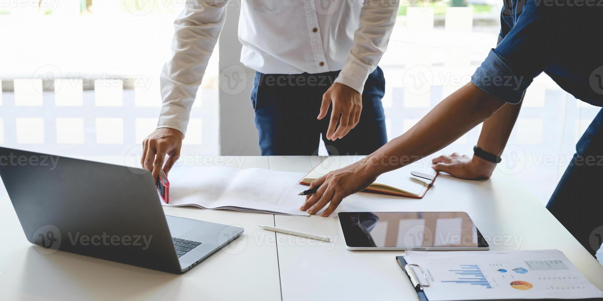 Two Architect man working with laptop and blueprints for architectural plan, engineer sketching a construction project concept. photo