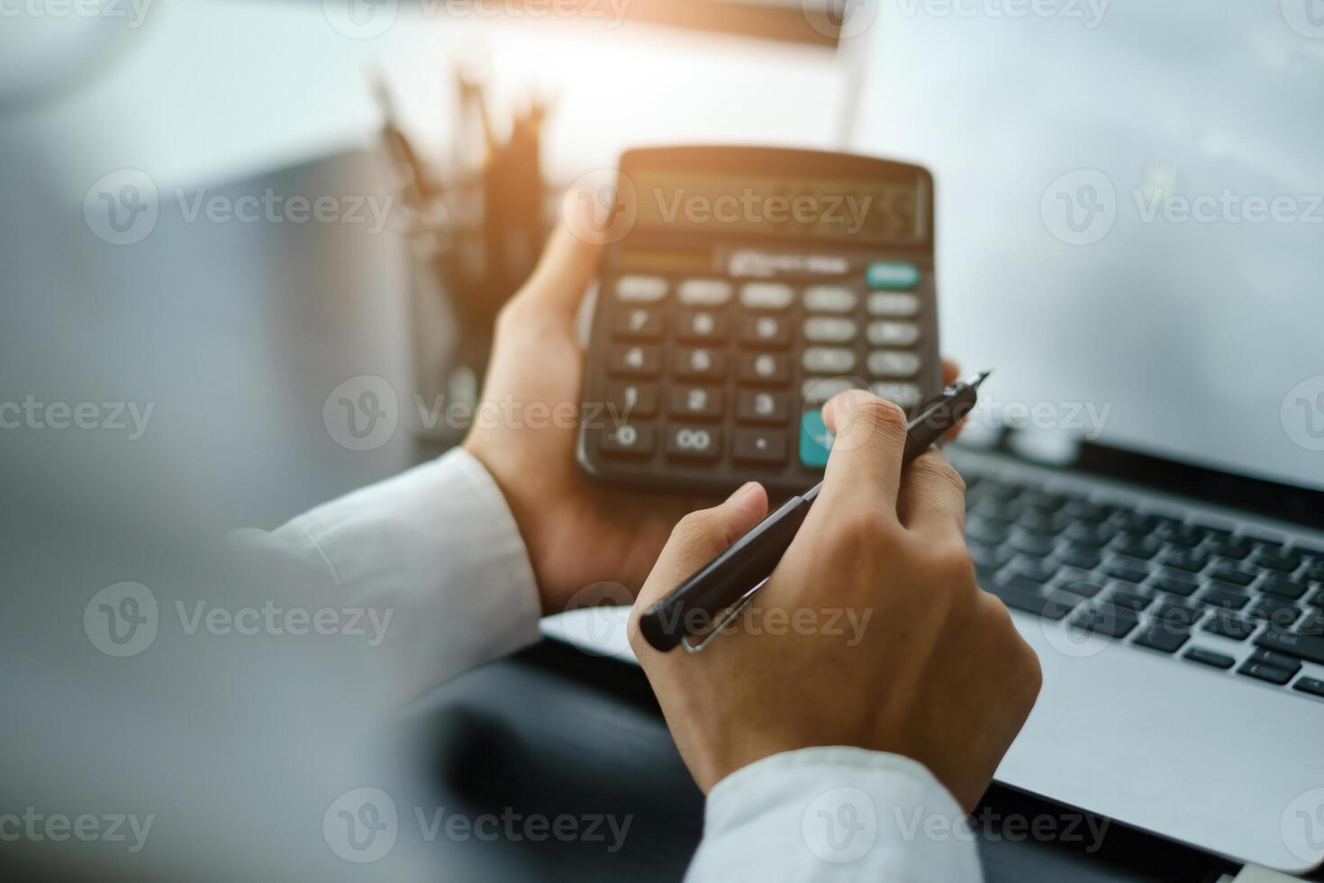 Businessman accountant using calculator. Stressed young man checking bank account balance, bills, taxes and calculating expenses at home office. photo