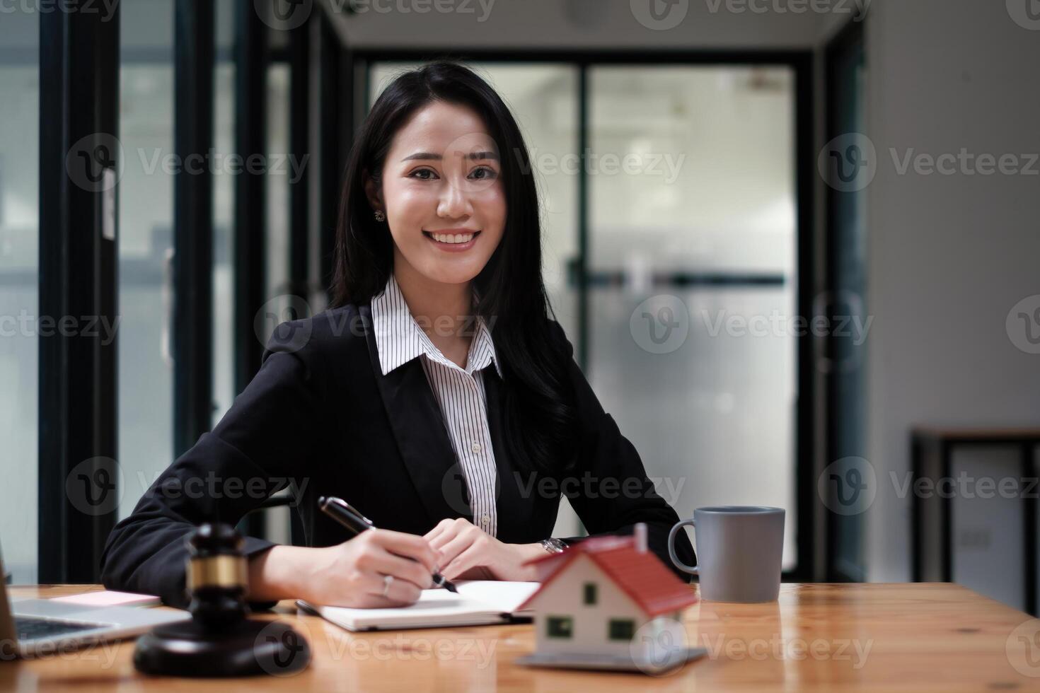 Business woman or legal advisor sitting wooden desk in office. Law, legal services, advice,Judge auction and real estate concept. photo