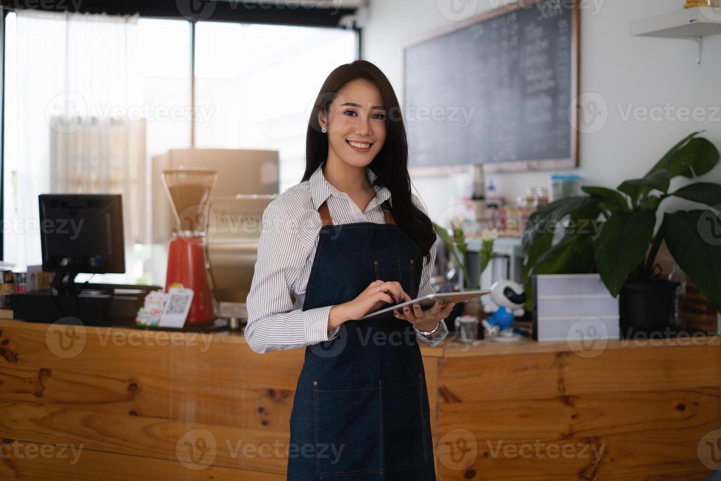 At her cafe, the business owner or barista is taking orders from customers photo