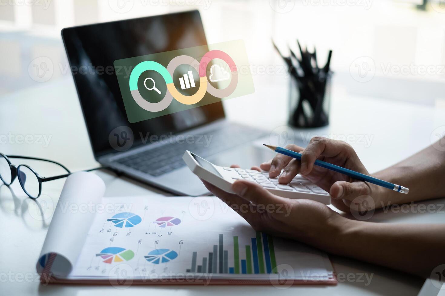 Close up businessman using a calculator to calculate the company's turnover results with virtual icon on screen. photo