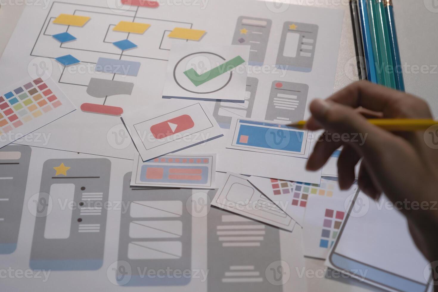 Designers drawing mobile ux app development concept. Man hold pencil with mockup ui. photo