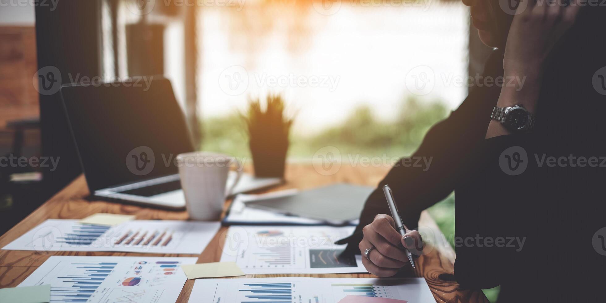 Stressed business woman hard working until morning and tired at table in office while project deadlines. finance, account, tax, audit concept. photo