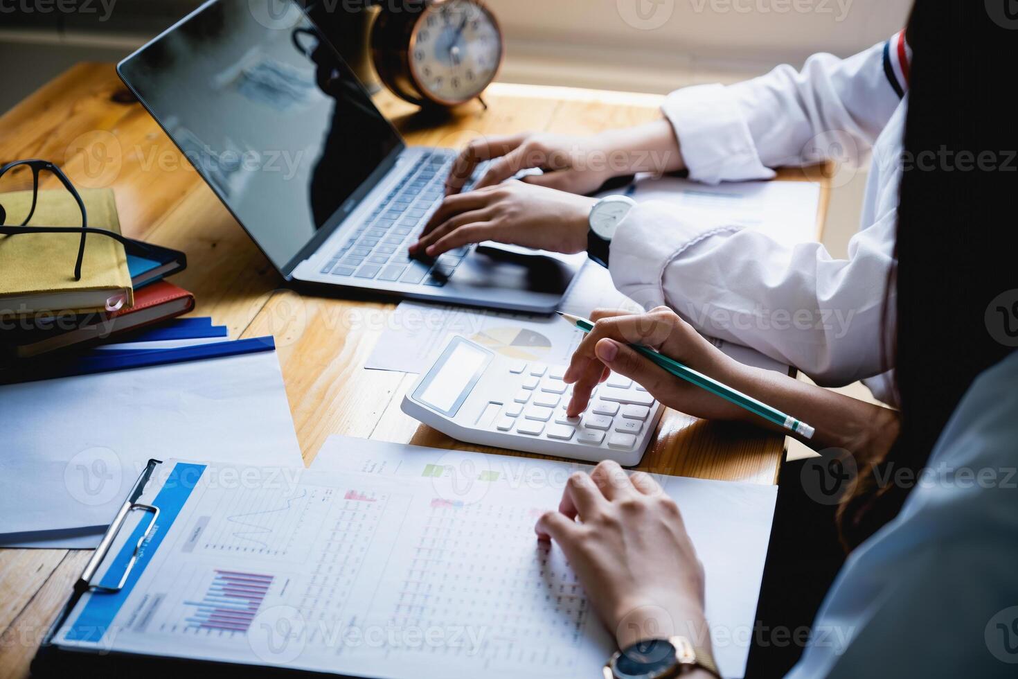 For the investigation of a corruption account, a group of businesswomen and accountants search data documents on a laptop. definition of anti-bribery photo