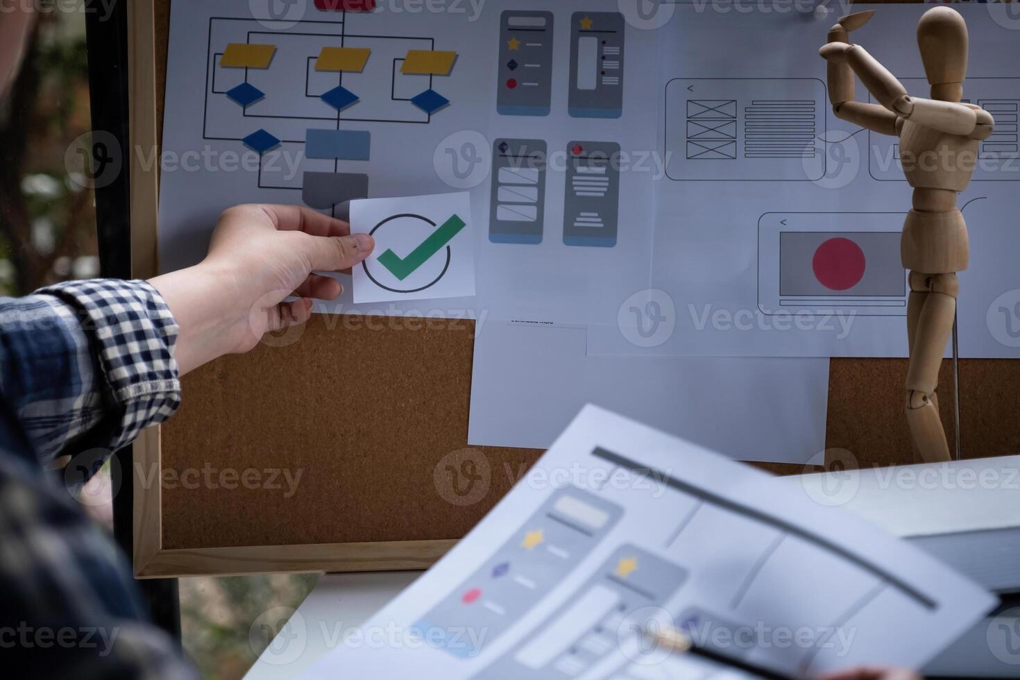 A close-up of an ux ui developer and an ui designer working on a mockup icon interface for a mobile app. photo