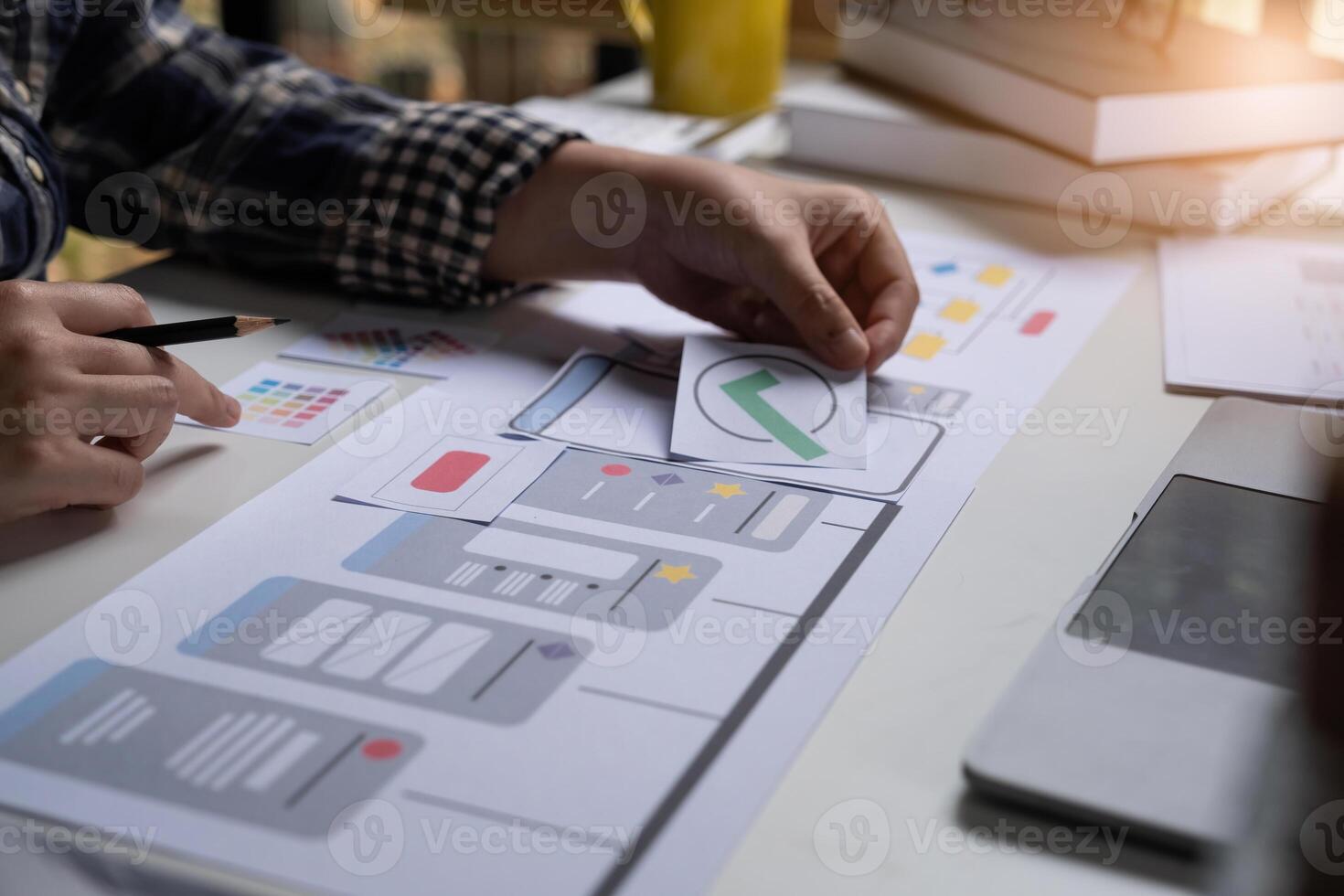 A close-up of an ux ui developer and an ui designer working on a mockup icon interface for a mobile app. photo