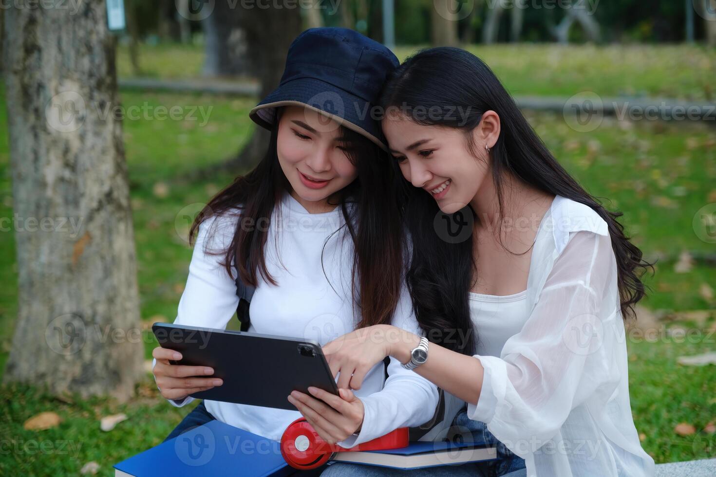 Friends or Family concept. Two Female using maps on tablet while travel. photo