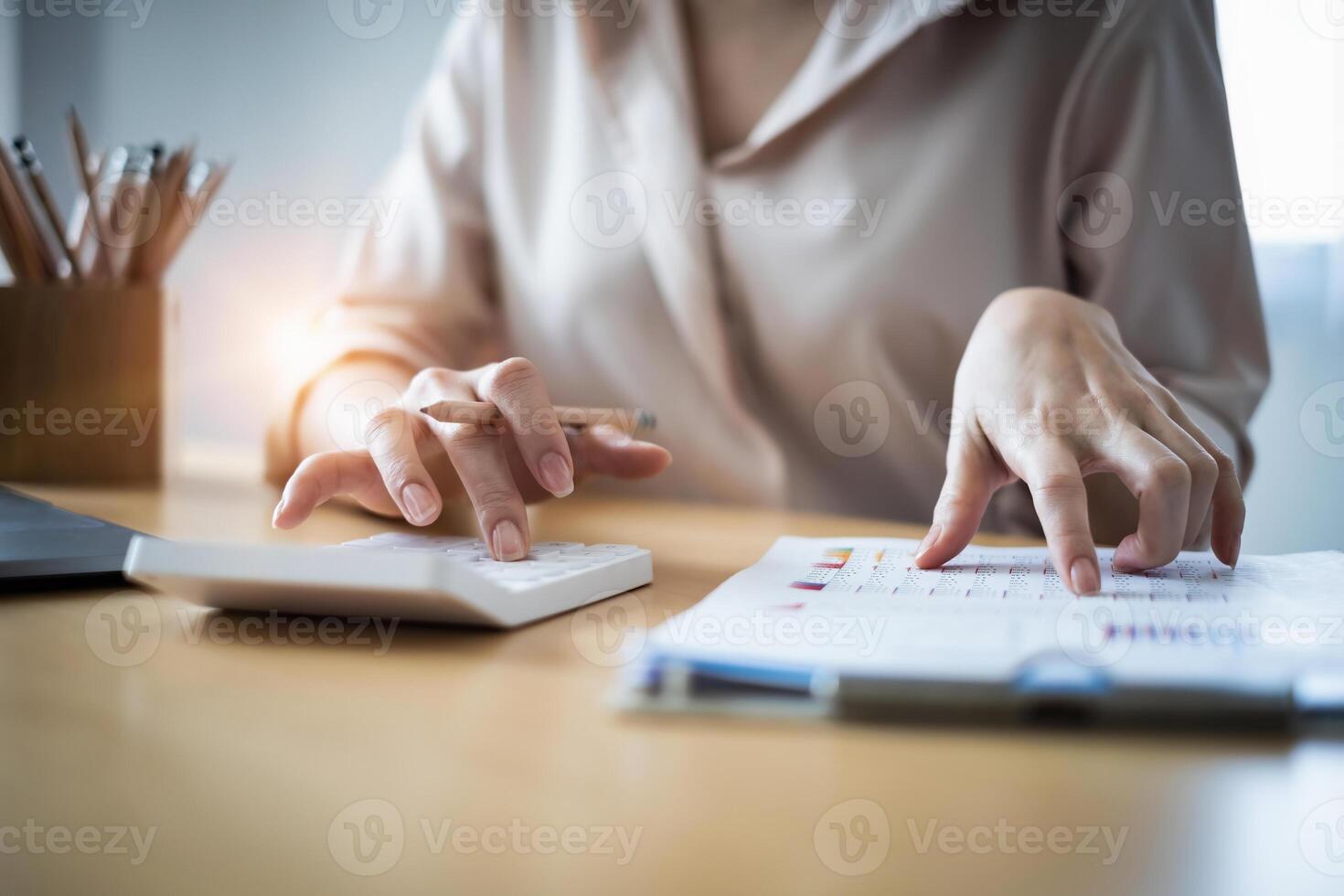 Young accountant man analyzes financial data using calculator and laptop computer to compute and summarize big data for present on conference. financial concept. photo