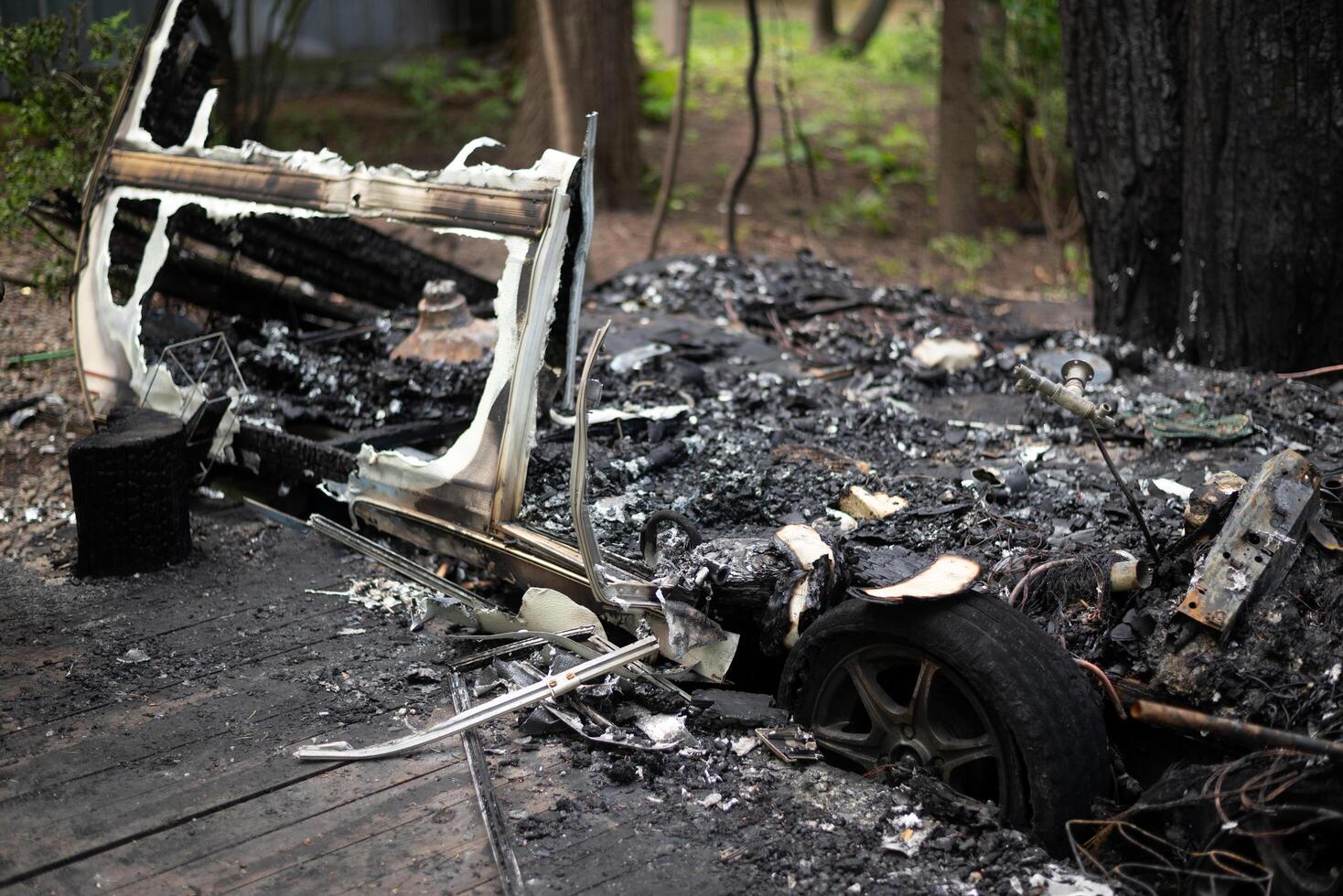 The remains of a burnt out mobile home trailer. photo