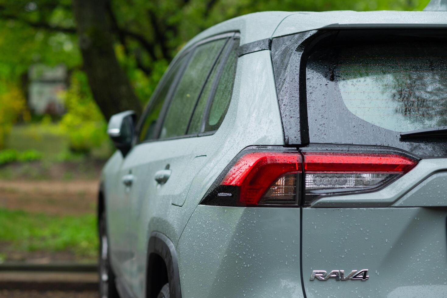 A portrait of the back of a green hybrid toyota rav4 car with the hybrid icon or logo. Kyiv, Ukraine - April 2024. photo