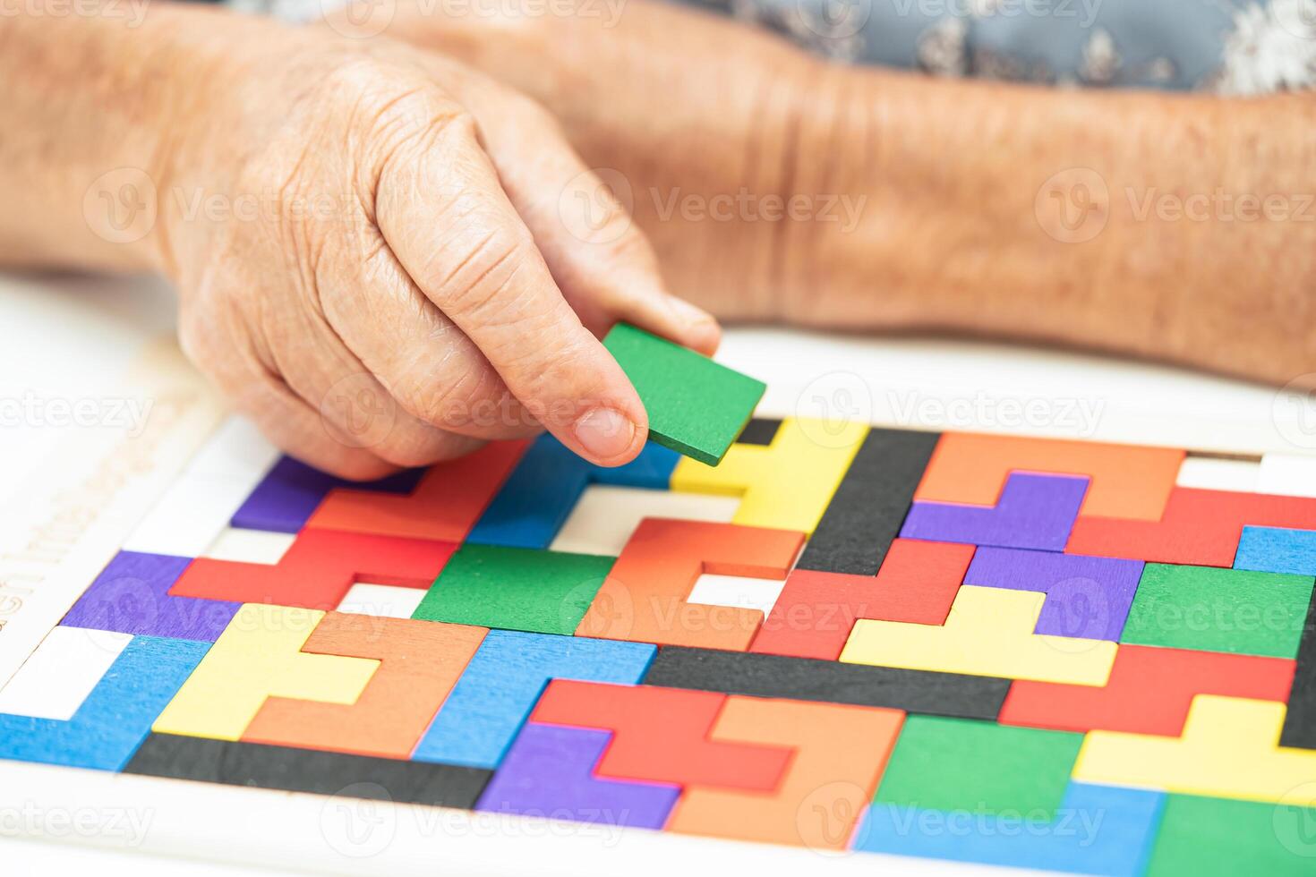 Alzheimer disease AD, Asian elderly woman patient suffering from dementia learn practical motor skills rehabilitation. photo
