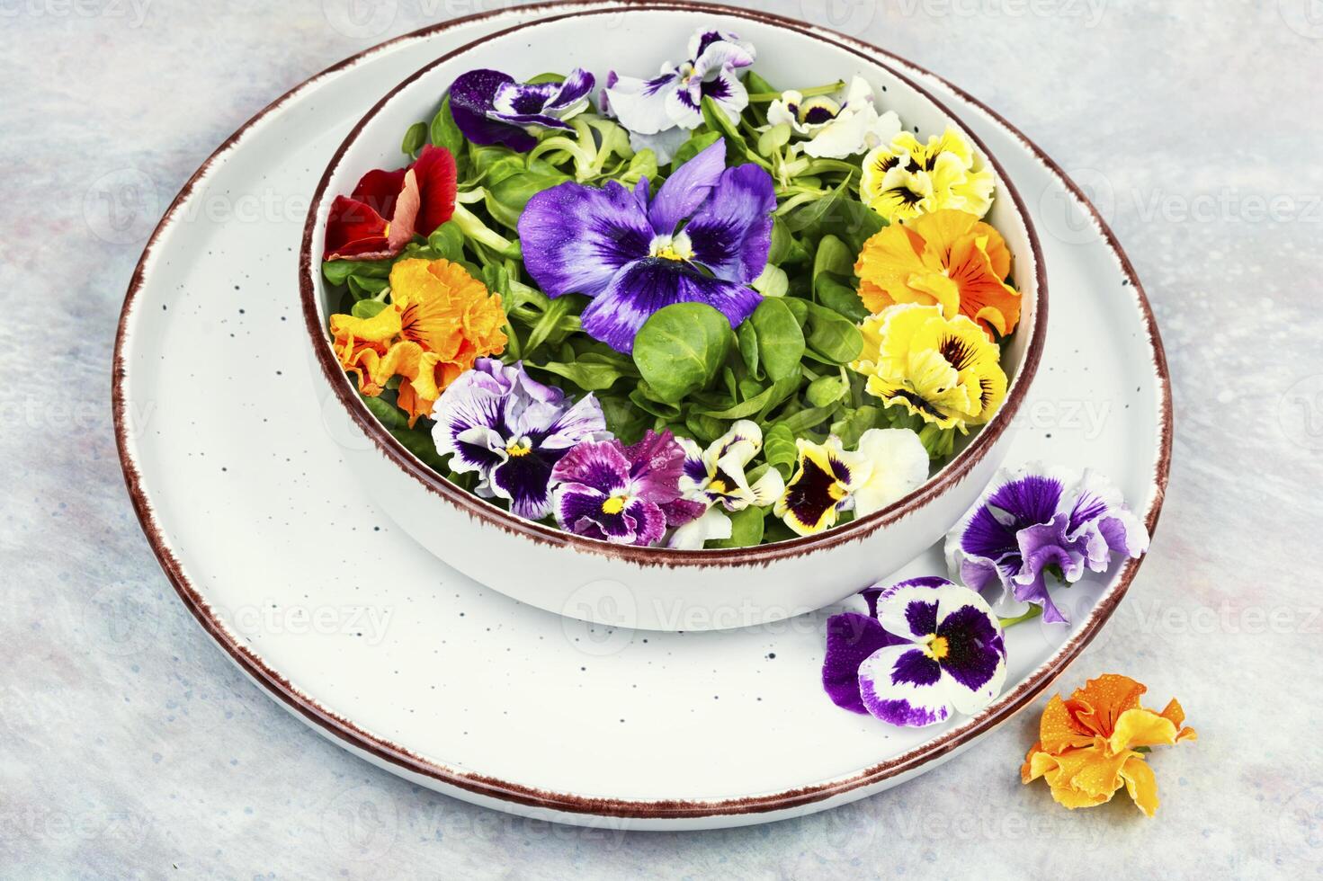 Salad of edible flowers, vegetarian food. photo