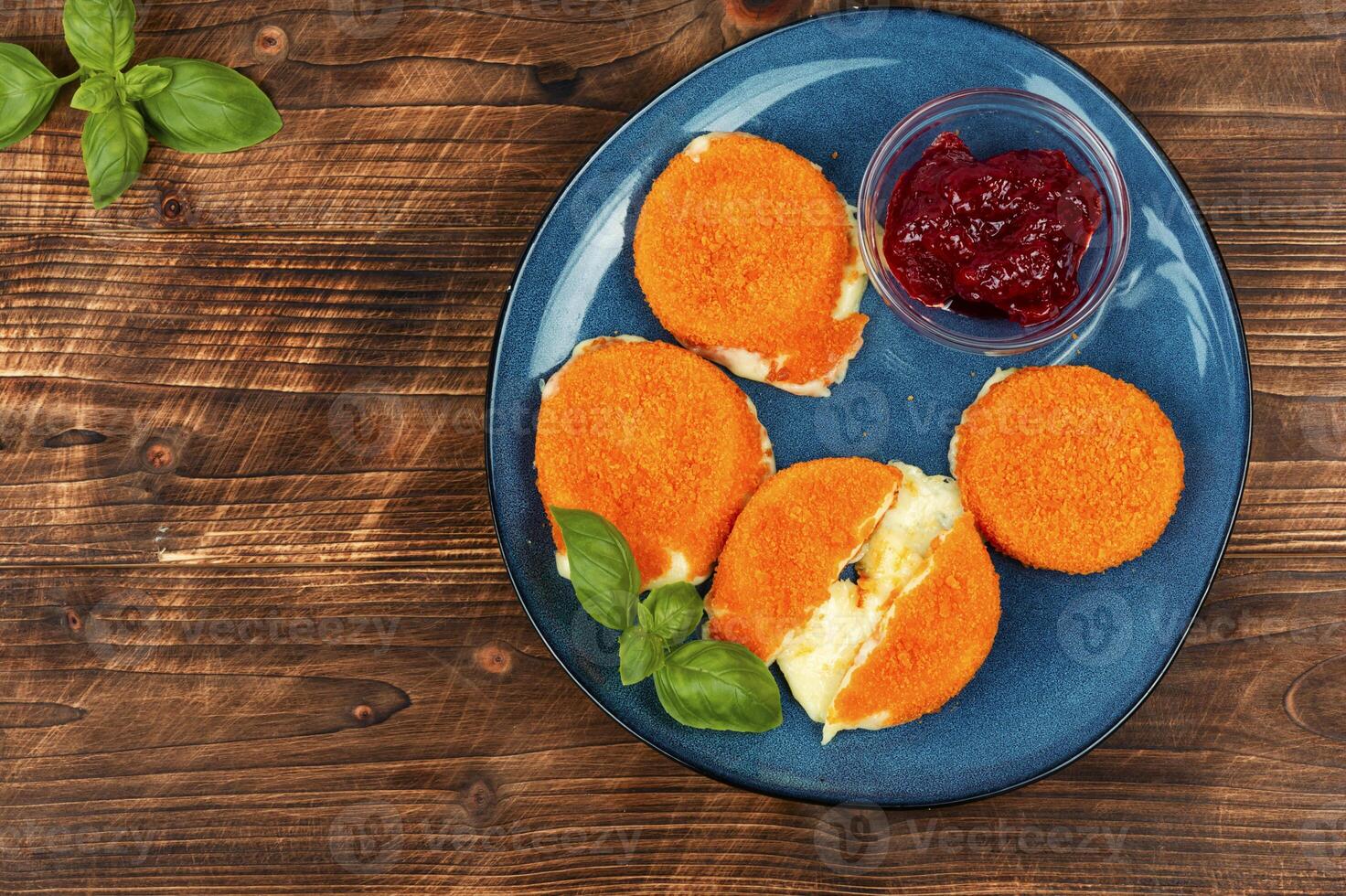 Delicious fried camembert cheese with sauce photo